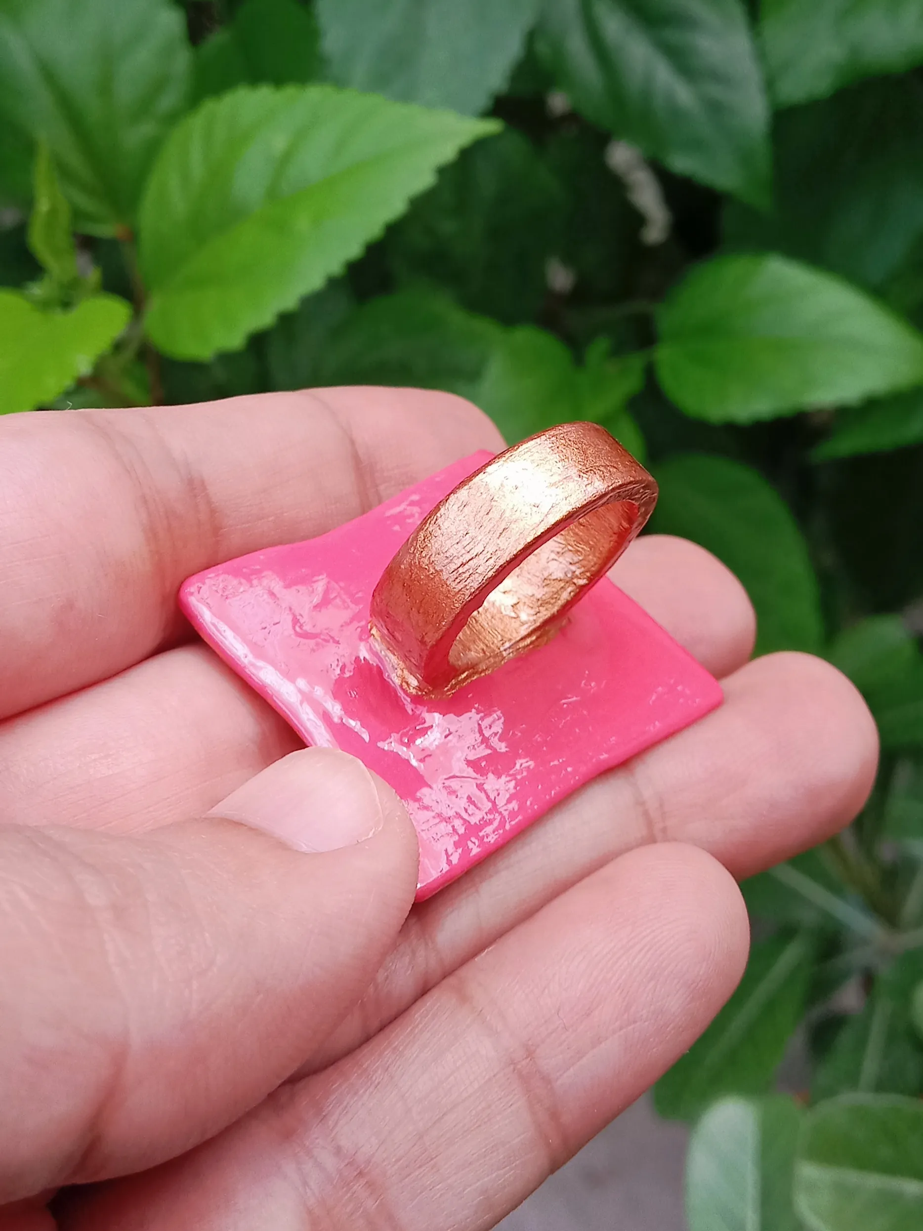 Side profile view showing the smooth, bronze-colored clay ring band with a glossy glass finish.
